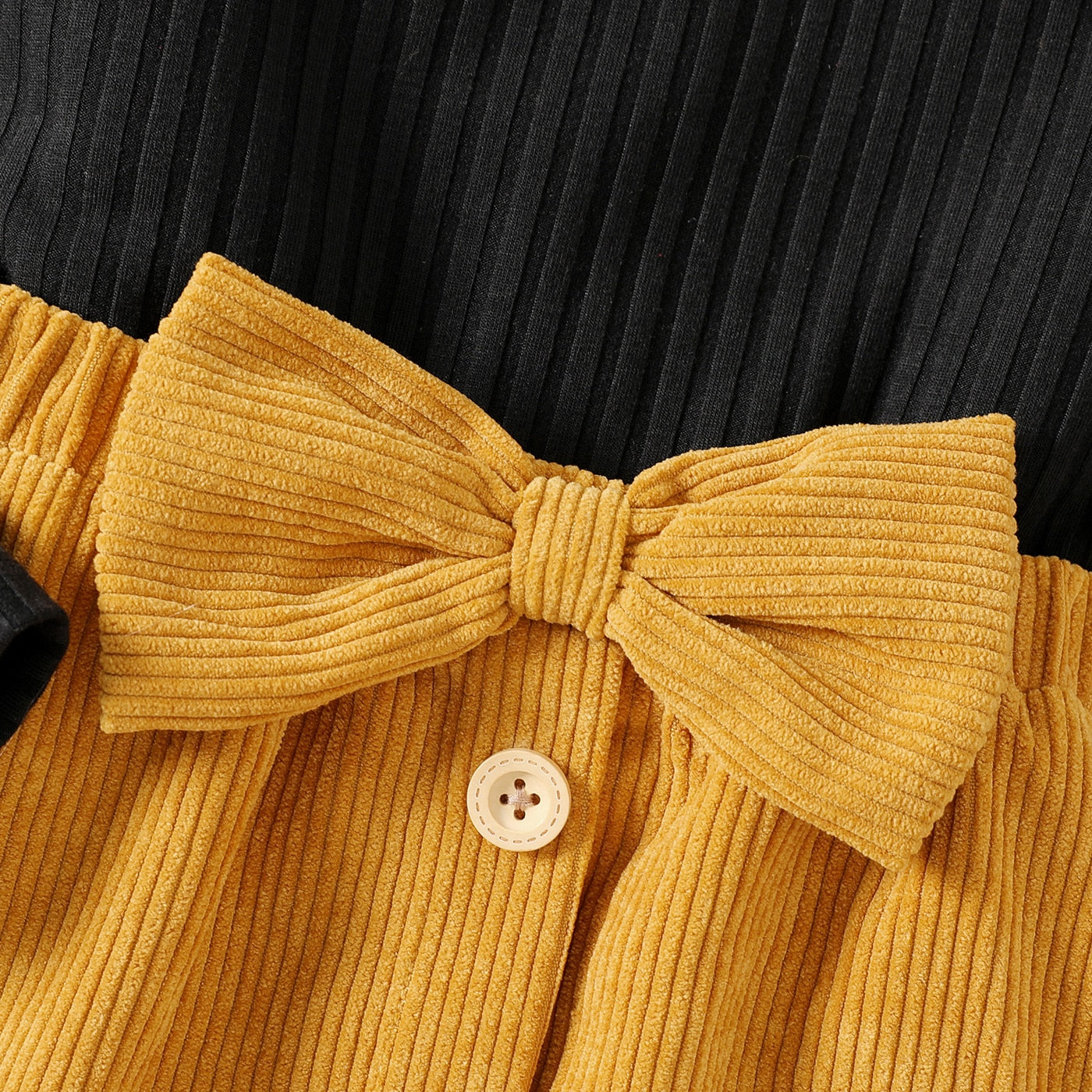 PatPat 2pcs Kid Girl Ribbed Long-sleeve Black Tee and Bowknot Button Design Skirt Set